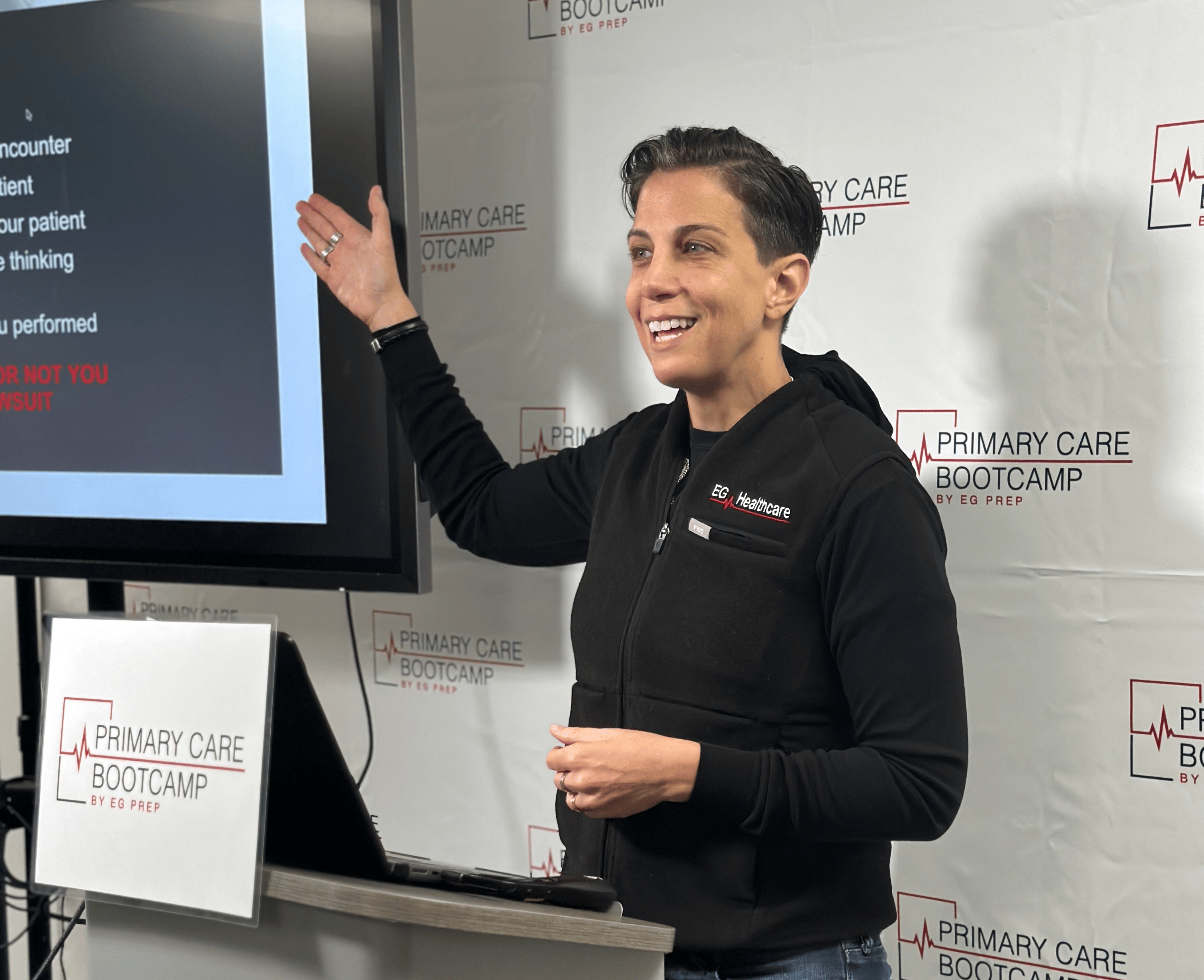 A woman giving a presentation on how to get started with SEO in front of a screen.